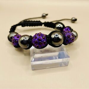 Shamballa style bracelet with purple crystal beads and hematite beads.